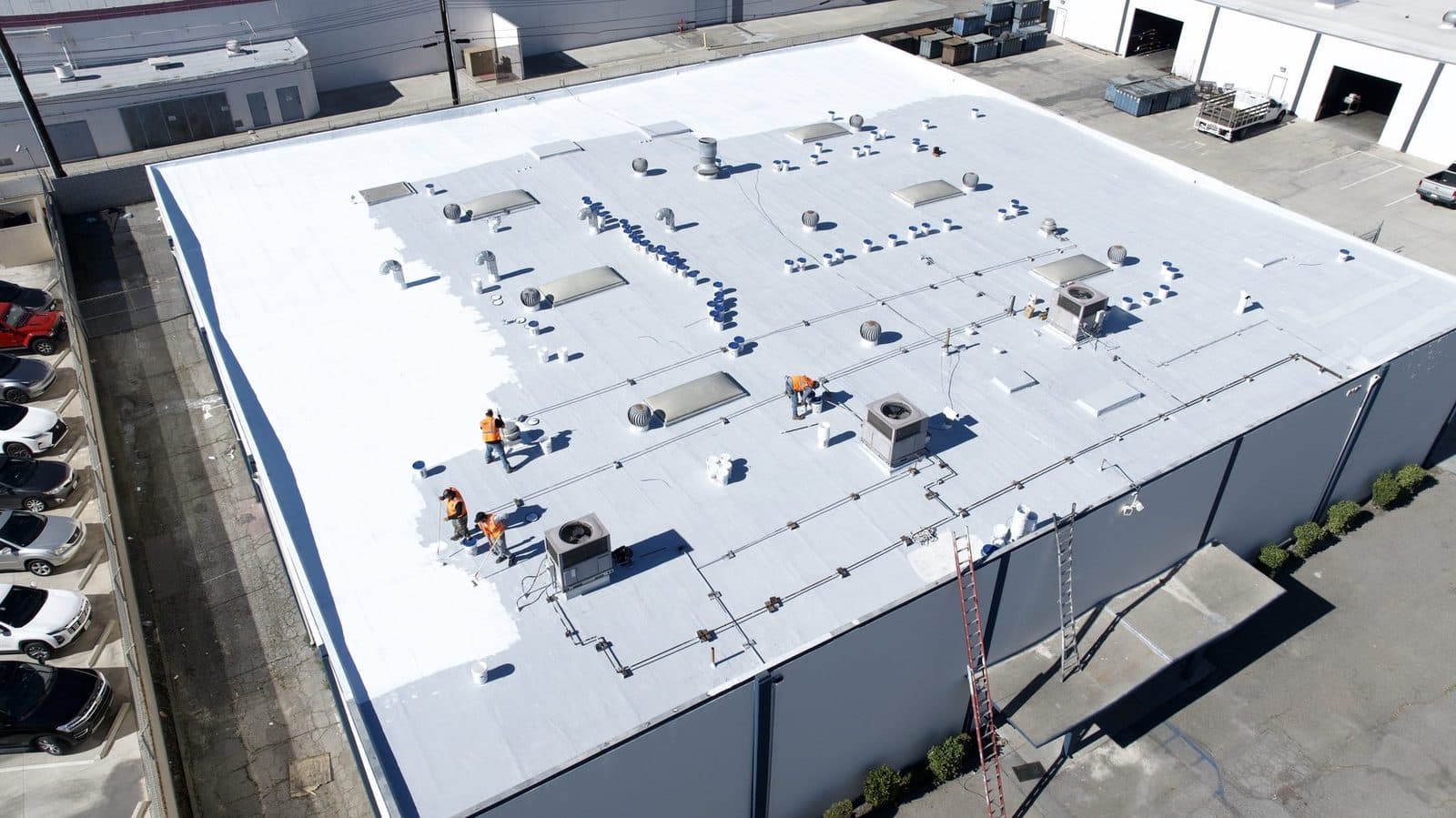 Aerial view of a crew working on a large commercial flat roof
