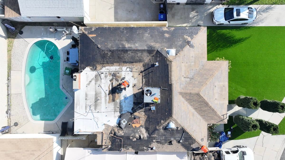 Aerial view of a roof tear-off in progress