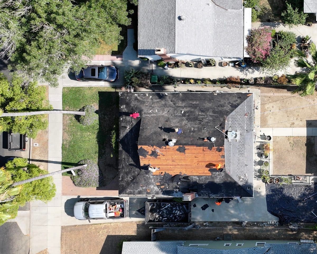 Aerial view of a roof tear-off with exposed decking