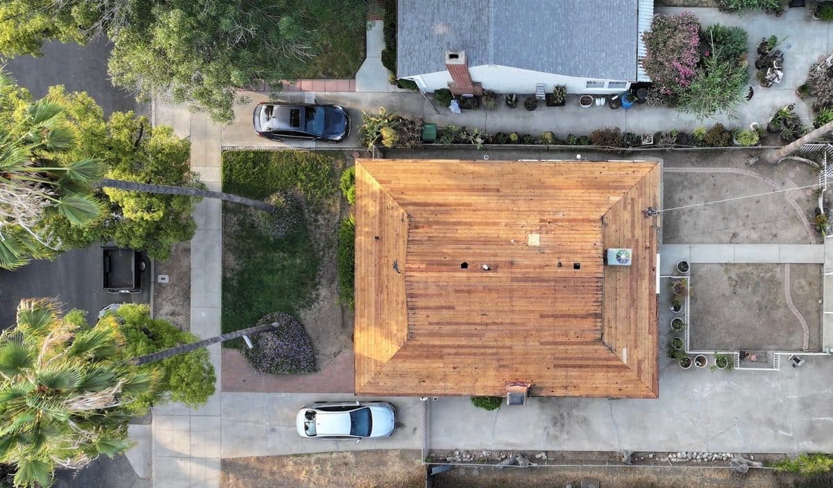 Aerial view of exposed wood roof decking during a tear-off