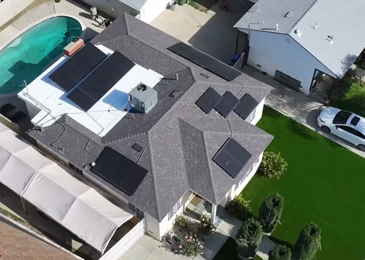 Aerial view of a completed roof with solar panels