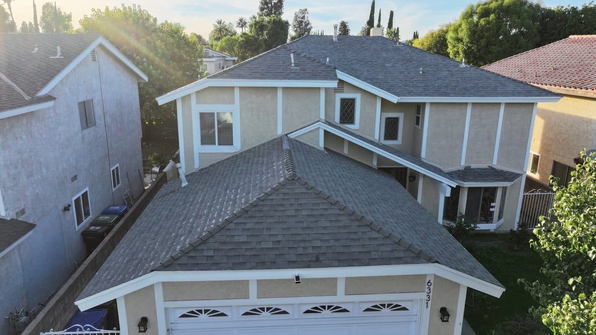 Completed gray shingle roof on a two-story home