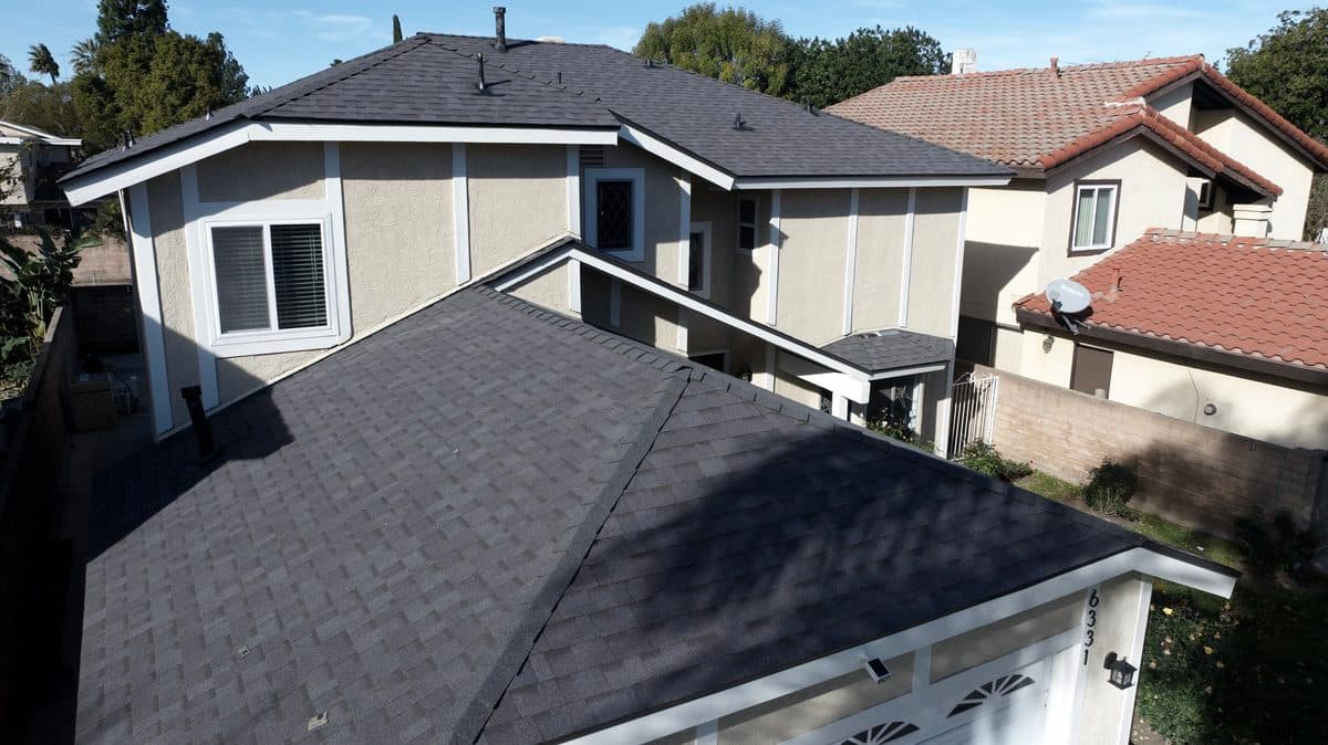 Completed dark gray shingle roof on a two-story home