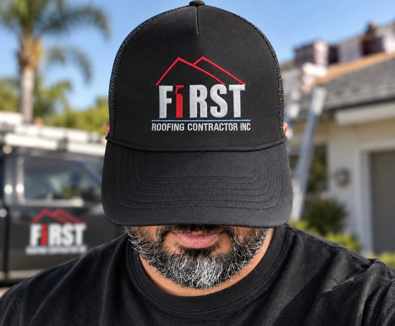 First Roofing Contractor branded cap in front of a company van and roofing job site